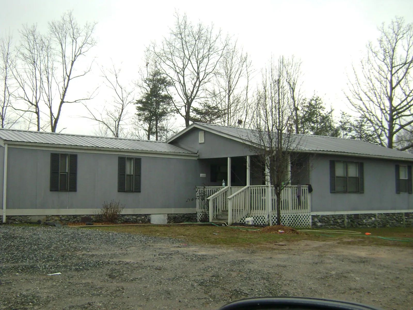 Metal roof over a manufactured home with a covered front porch in Girard
